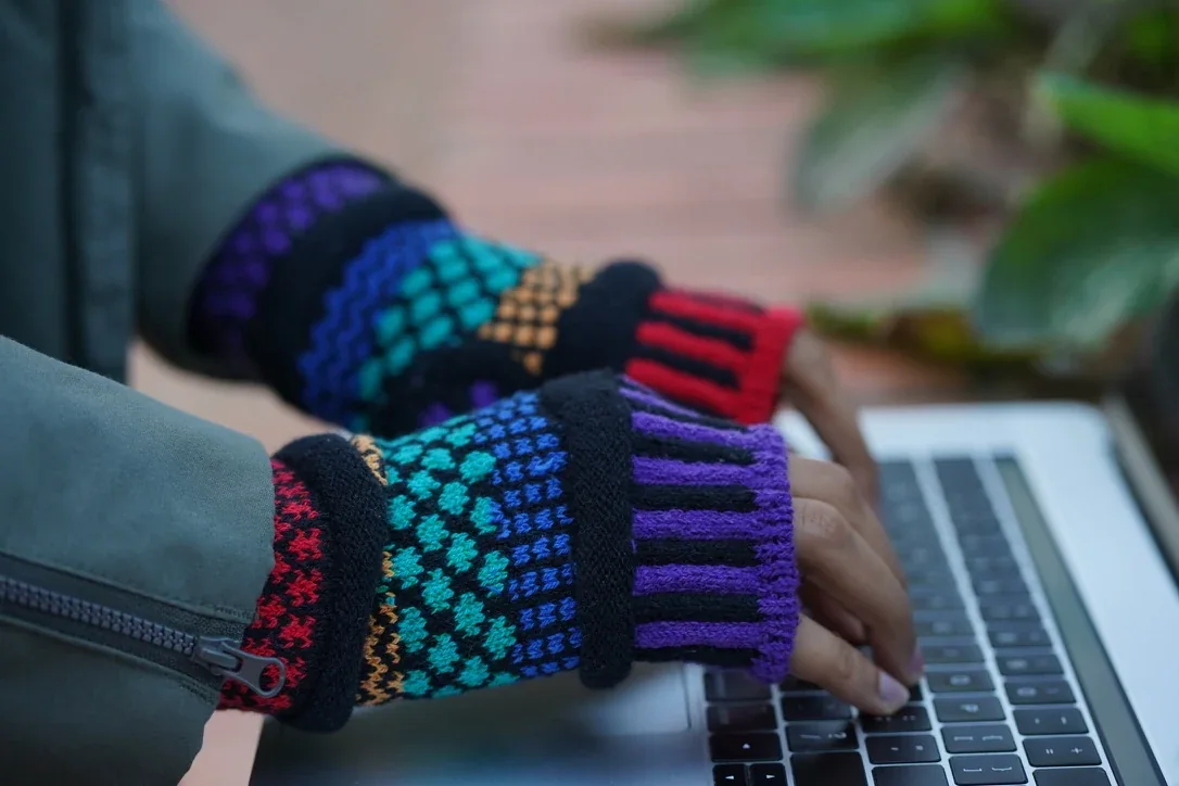 Fingerless glove detail at the keyboard.